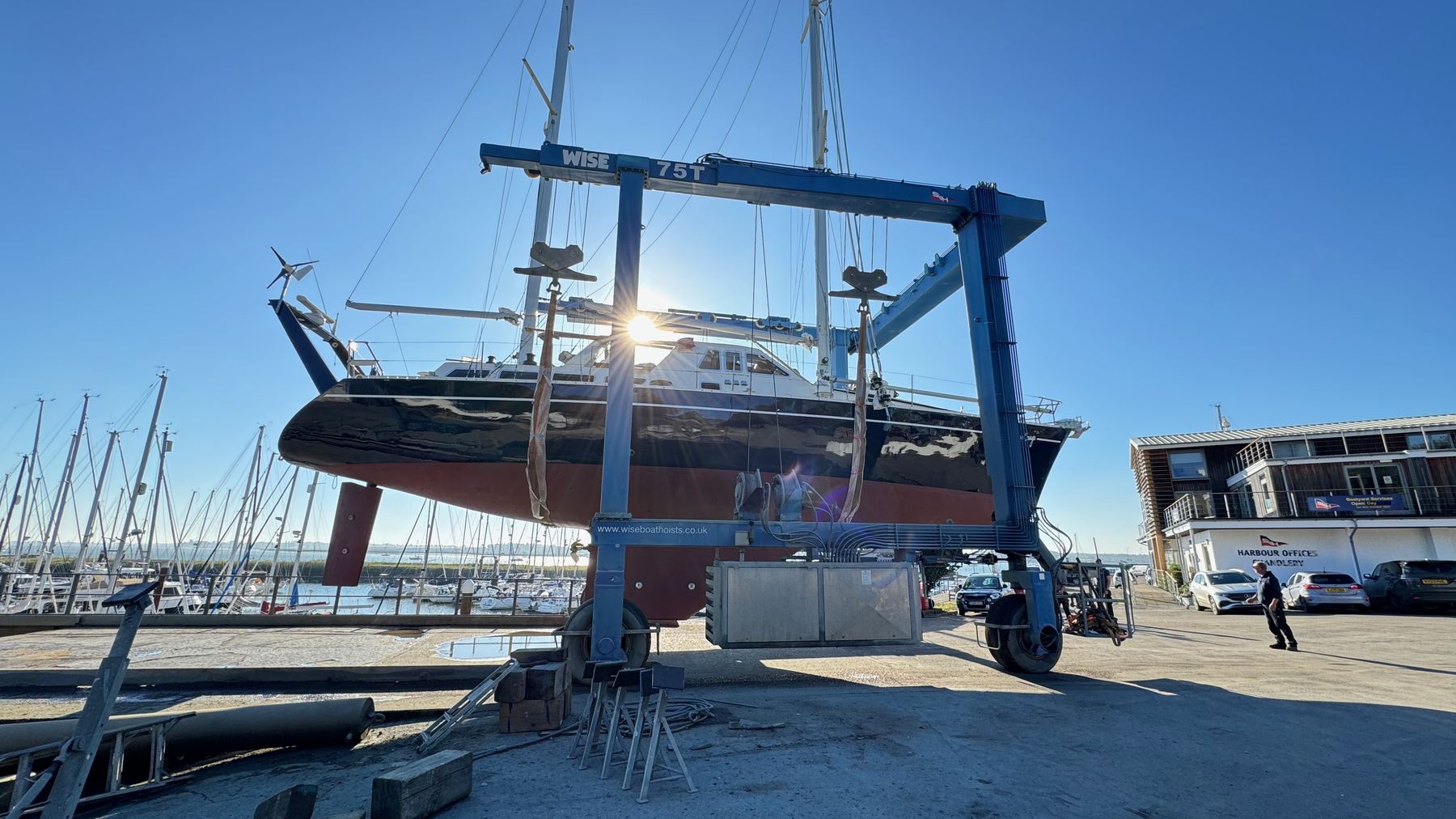 Superyacht suspended in a boatyard lift